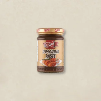 Jar of Suree tamarind paste on a light beige background with a gold cap and tan label reading 'TAMARIND PASTE'