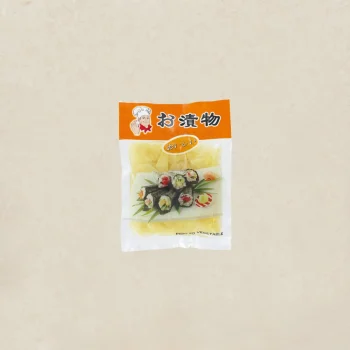 Bag of pickled vegetables in a plastic package with an orange header and Japanese text, showing sushi image on the front.