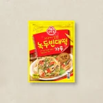 Yellow Ottogi mung bean pancake mix packet with a bold red label and an image of savory pancakes on a plate.