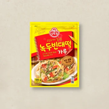 Yellow Ottogi mung bean pancake mix packet with a bold red label and an image of savory pancakes on a plate.
