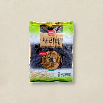 Bag of dried black beans in a green-and-beige plastic package with Korean text and a red 'Natural' label