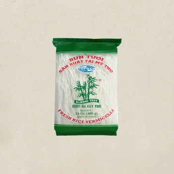 Bag of vermicelli rice with green top and bottom, bamboo graphic, and red Vietnamese labels on a beige background.