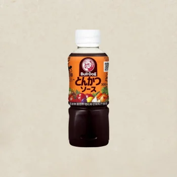 Bull-Dog tonkatsu sauce bottle with an orange label and white cap, centered on a light background