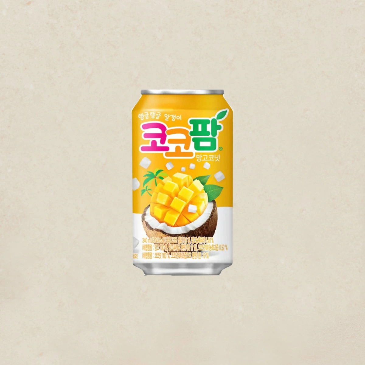 Haitai Coco Palm Juice Mango 코코팜망고 340ml Can of Korean mango-coconut drink with a tropical mango image on a yellow label, set against a beige background.