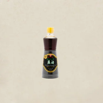 Bottle of Kadoya roasted sesame oil with a yellow cap, dark brown liquid visible through the neck, labeled 100% pure.