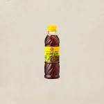 Bottle of Korean plum syrup with a bright yellow cap, centered on a neutral background.