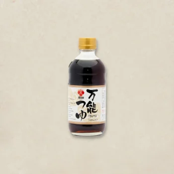 Bottle of tsuyu soy sauce with a gold cap, label shows TSUYU 340 ml on a beige background