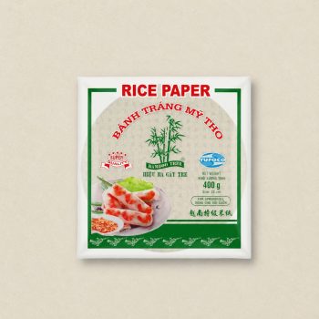 Rice paper package with green border, bamboo logo, and a plate of fresh spring rolls.