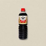 Bottle of Yamasa soy sauce with red cap on a neutral background (label reads 'Yamasa Soy Sauce')