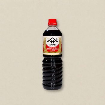 Bottle of Yamasa soy sauce with red cap on a neutral background (label reads 'Yamasa Soy Sauce')