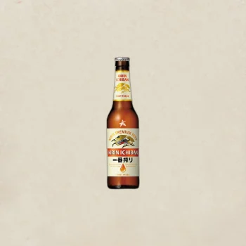 Bottle of Kirin Ichiban beer centered on a light beige background