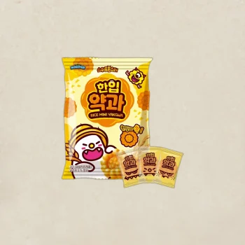 Bright yellow snack bag labeled Rice Mini Yakgwa with cartoon character, plus three small matching pouches next to it.