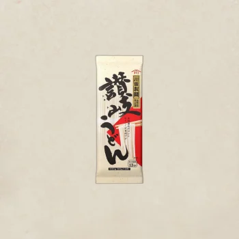 Vertical Japanese udon noodle package with bold black kanji on a beige background and a red accent panel.
